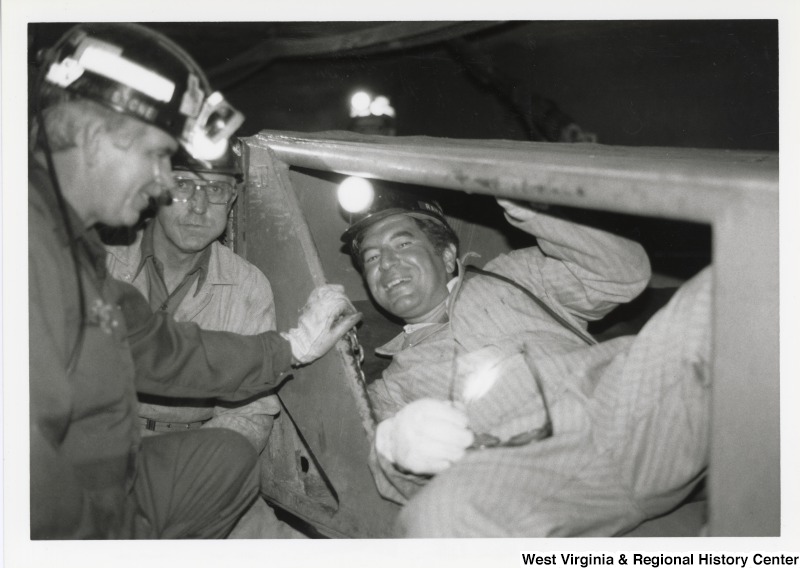 Congressman Nick Rahall inside of mine car at Old Ben Coal Mine with two unidentified coal miners.